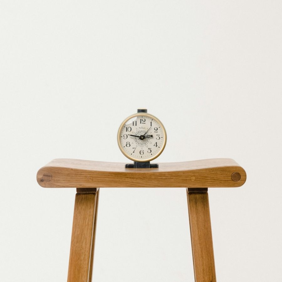 clock on a table, white background