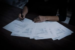 person indoors working on tax reports