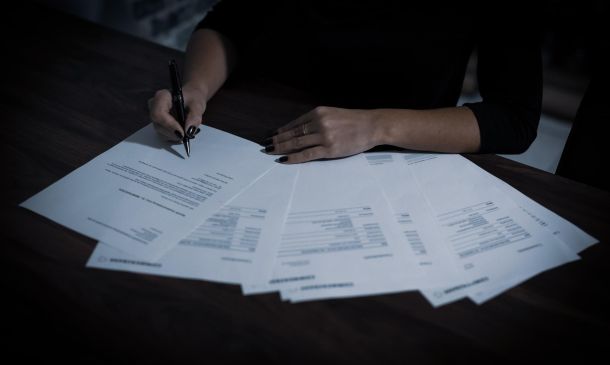 person indoors working on tax reports